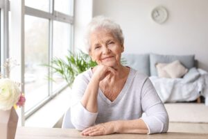 a senior smiles after reviewing senior living options