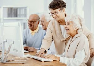 seniors learning how to use computer in educational program