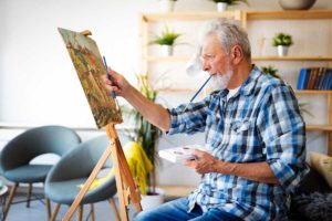 senior man painting and enjoying activities of daily living