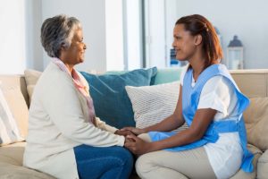 a woman and her caregiver discuss moving into assisted living