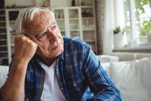older man sitting and thinking about what is alzheimer's, what is dementia, dementia vs alzheimer's