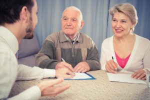 a senior living specialist speaks with a senior couple who are wondering about paying for senior living