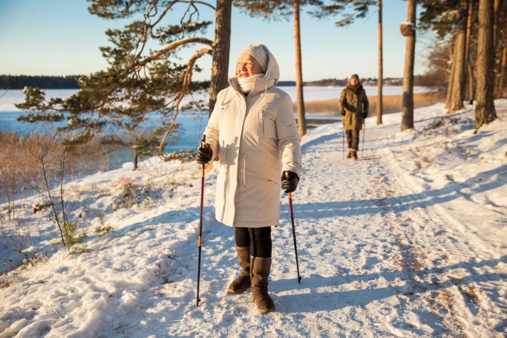a senior walks in the snow, one of many winter activities for seniors