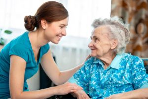 a nurse with a career in senior living talks to a senior