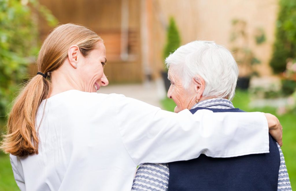 a nurse comforts a senior in dementia care in dallas, texas