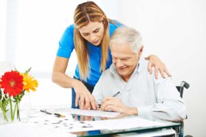 a nurse helps a senior write, one of the benefits of memory care