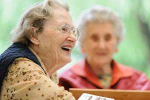 a group of seniors interacts in an independent senior living community