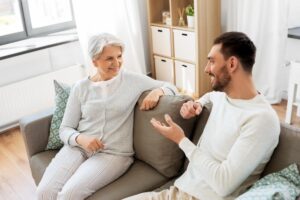 an adult child talks with a senior parent about the benefits of senior living community