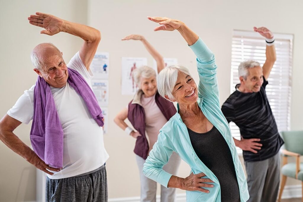 a group of seniors does stretching exercises for seniors