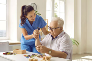 a nurse performs senior memory care therapy with a resident