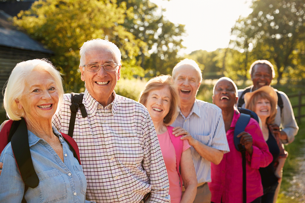 a group of seniors stands outside as they engage in Group activities for seniors