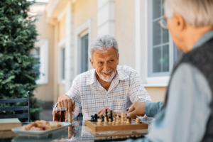 two seniors play chess, one of many new hobbies for seniors