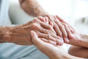 a person holds someone elses hand after asking how often can you use respite care?