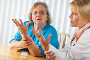 a nurse guides a resident through physical therapy for senior citizens