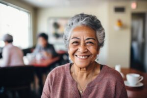 a senior adult smiles after learning about the Pros and Cons of a Senior Living