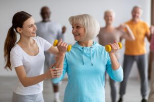 a therapist helps lead a group in Exercises for Seniors to Improve Mobility and Strength