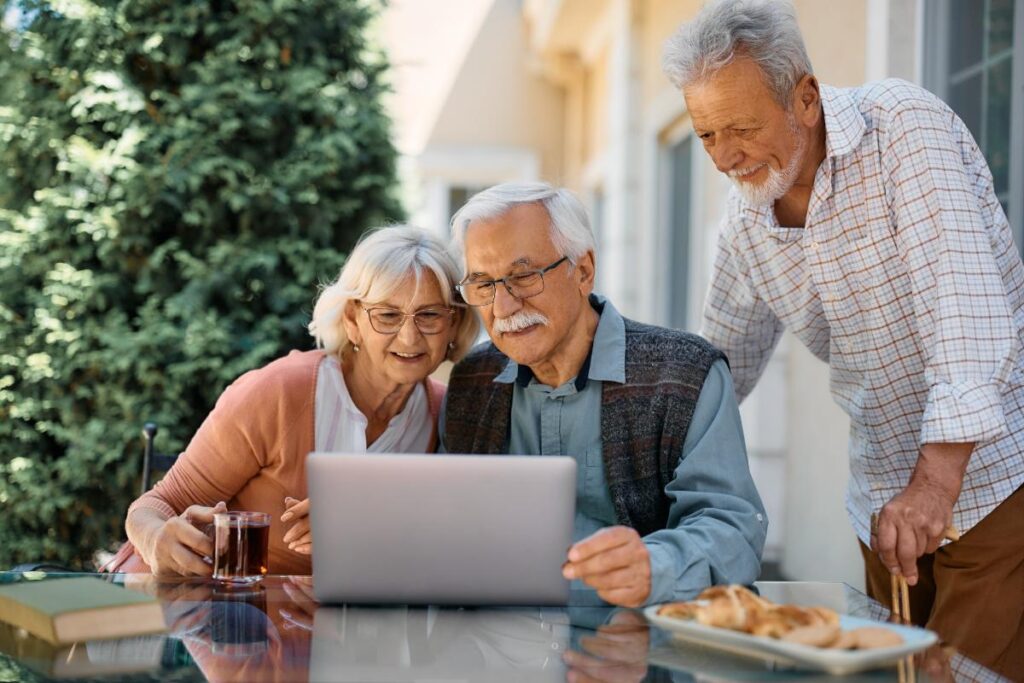 a group of seniors uses a computer to research Buckner Senior Living Services