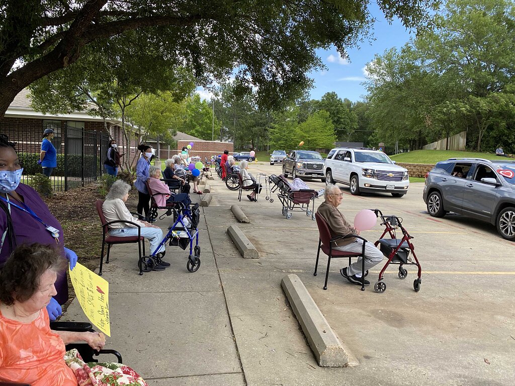 Elderly senior living residents line up to watch a parade